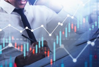 Businessman taking notes, graphs image overlay